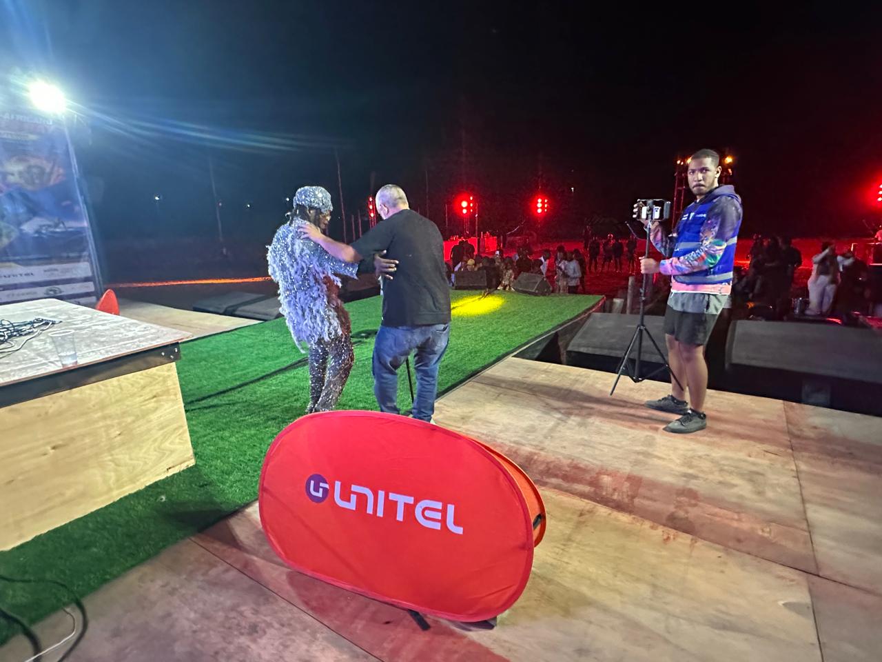 Stage performance alongside UNITEL branding